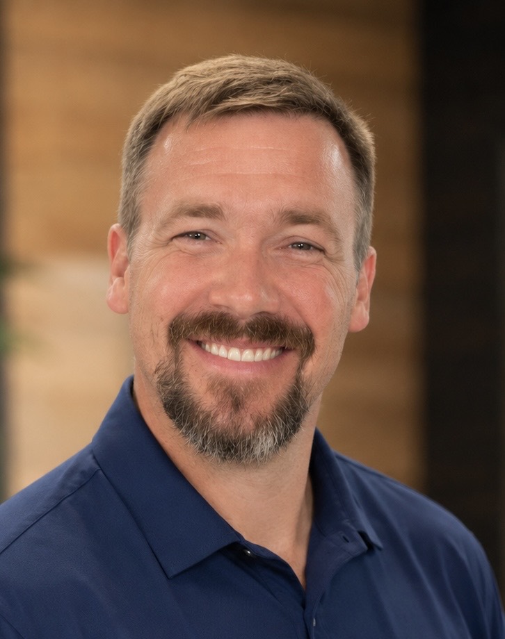 Casey Moore smiling in a navy shirt